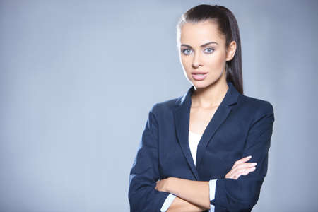 Portrait of beautiful business woman on gray backgroundの写真素材