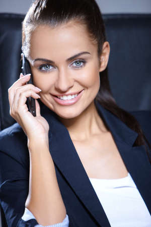 Portrait of beautiful business woman sitting on chairの写真素材