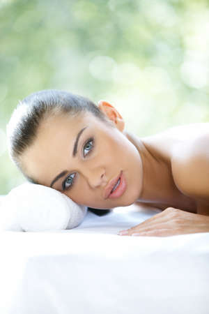 Beautiful woman is resting on spa bedの写真素材