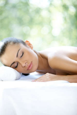 Beautiful woman is resting on spa bedの写真素材
