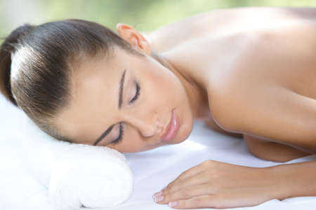Beautiful woman is resting on spa bedの写真素材