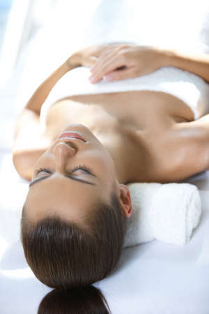 Beautiful woman is resting on spa bedの写真素材