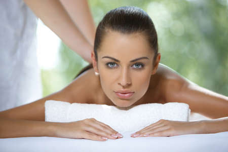 Beautiful woman is resting on spa bedの写真素材