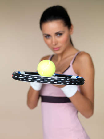 Beautiful female tennis player on natural backgroundの写真素材