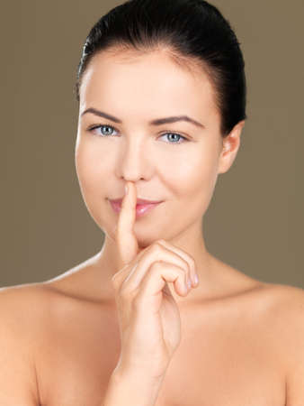 Portrait of beautiful woman, she doing quiet gestureの写真素材