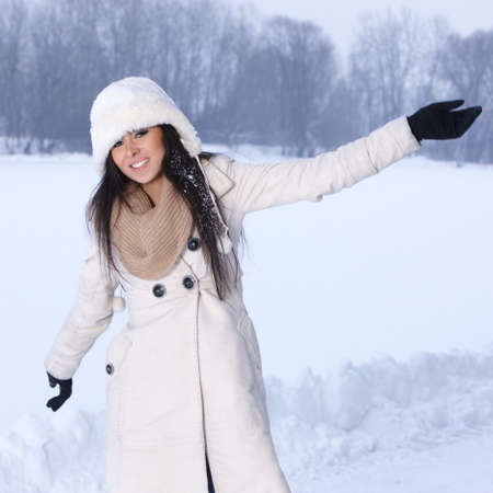 Beautiful and sexy woman in snowy winter outdoorsの写真素材