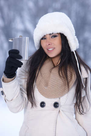 Beautiful and sexy woman in snowy winter outdoorsの写真素材