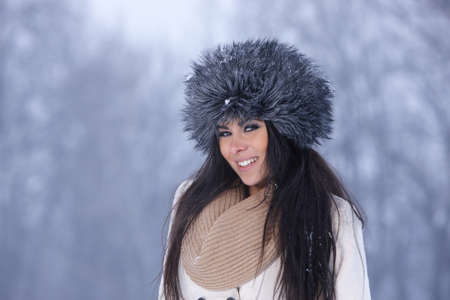 Beautiful and sexy woman in snowy winter outdoorsの写真素材