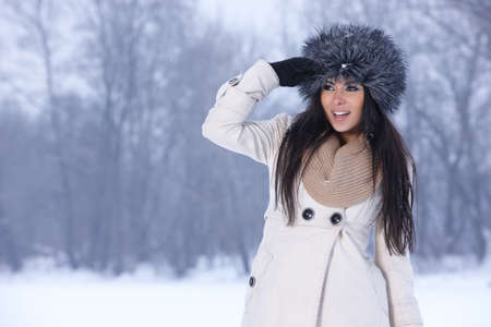 Beautiful and sexy woman in snowy winter outdoorsの写真素材