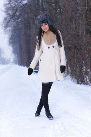 Beautiful and sexy woman in snowy winter outdoorsの写真素材