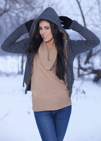 Beautiful and sexy woman in snowy winter outdoorsの写真素材