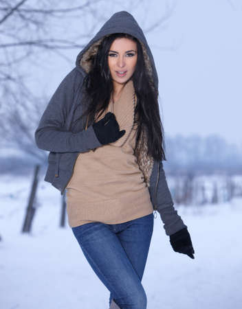 Beautiful and sexy woman in snowy winter outdoorsの写真素材