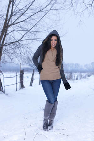 Beautiful and sexy woman in snowy winter outdoorsの写真素材