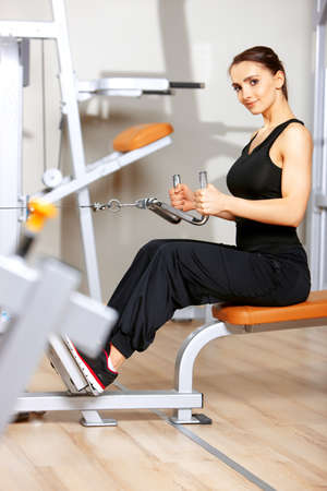 Beautiful woman exercising at the fitness gym