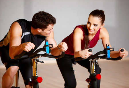 Sporty couple exercising at the fitness gymの写真素材