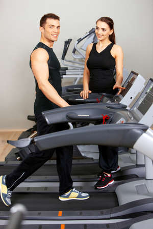 Sporty couple exercising at the fitness gymの写真素材