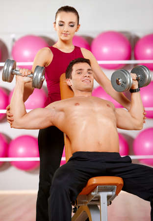 Sporty couple exercising at the fitness gymの写真素材
