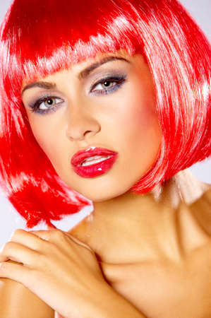Portrait of beautiful sexy woman in red wigの写真素材