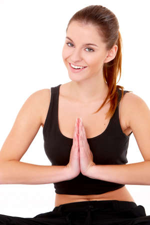 Portrait of pretty young woman doing yoga on whiteの写真素材