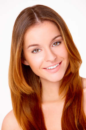 Portrait of beautiful young smiling woman isolated on whiteの写真素材