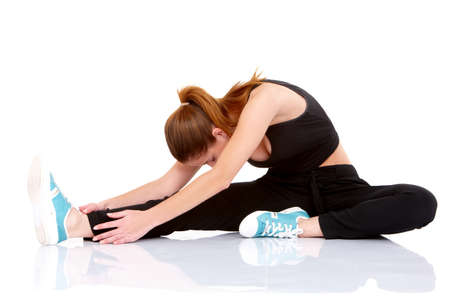Beautiful fitness woman doing stretching exercise on whiteの写真素材
