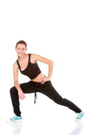 Beautiful fitness woman doing stretching exercise on whiteの写真素材