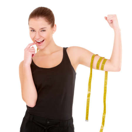 Fitness woman with measure tape on white backgroundの写真素材