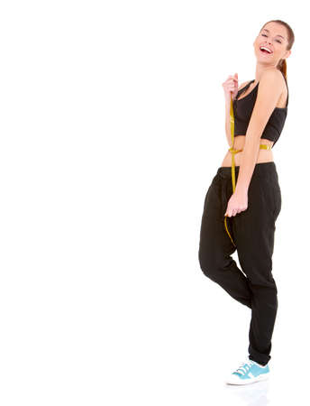 Fitness woman with measure tape on white backgroundの写真素材
