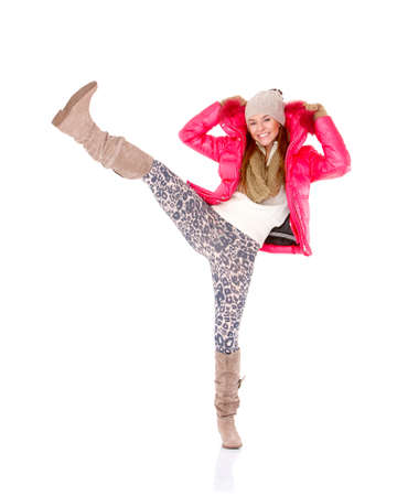 Happy young woman wearing winter jacket scarf and capの写真素材