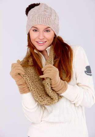 Young cute woman wearing warm clothes on whiteの写真素材