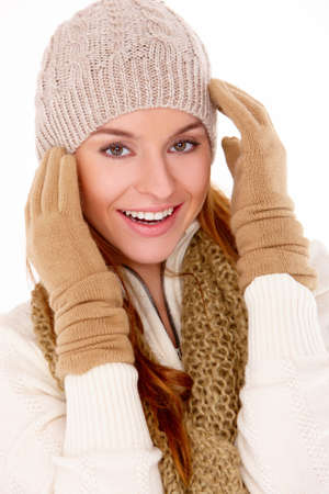 Young woman wearing warm winter clothes on whiteの写真素材