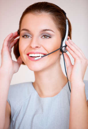 Portrait of a young attractive business woman with headsetの写真素材