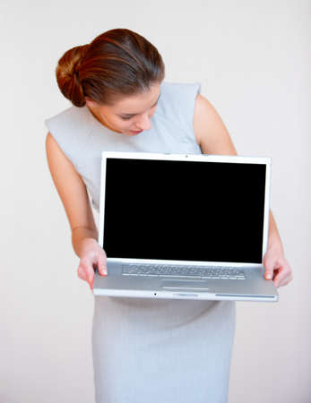 Portrait of a young attractive business woman with laptop computerの写真素材
