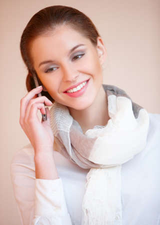 Portrait of young sexy brunette woman talking mobile phoneの写真素材