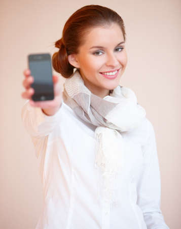 Portrait of young sexy brunette woman with mobile phoneの写真素材