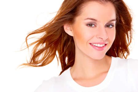 Portrait of cute young woman over white backgroundの写真素材