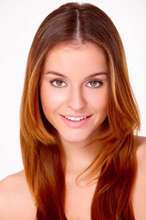Portrait of beautiful young smiling woman isolated on whiteの写真素材