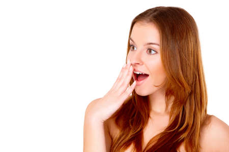 Portrait of beautiful young surprised woman isolated on whiteの写真素材