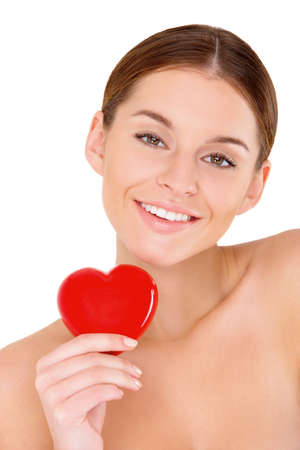 Portrait of beautiful young woman with red heart on whiteの写真素材