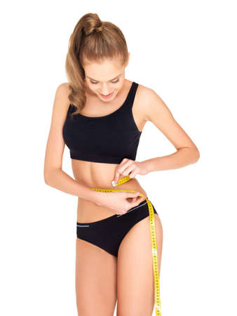 Fitness woman in black sports clothes isolated on whiteの写真素材