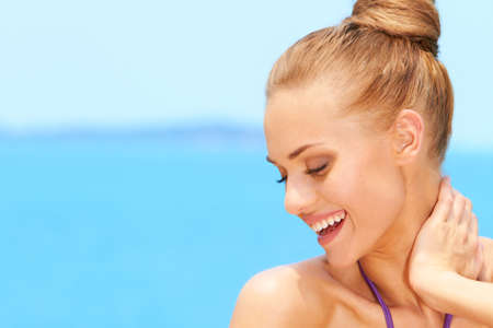 Portrait of charming young woman smiling with eyes closedの写真素材