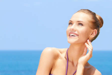 Portrait of gorgeous young woman smiling while looking at her rightの写真素材