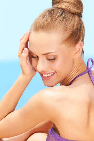 Closeup of dreaming young woman smiling outdoorsの写真素材