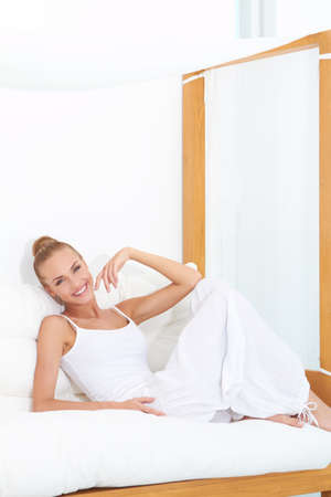 Woman relaxing on a canopied seat enjoying luxuryの写真素材