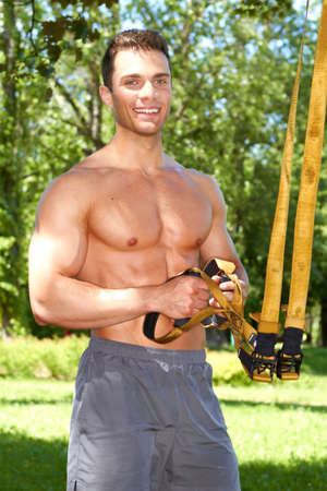 Portrait of good looking fitness man in parkの写真素材