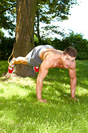 Well build man making push ups in parkの写真素材