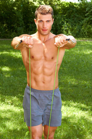 Muscular Male Improving his strength at outdoorの写真素材