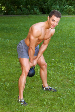 Handsome man Doing exercises with weightの写真素材