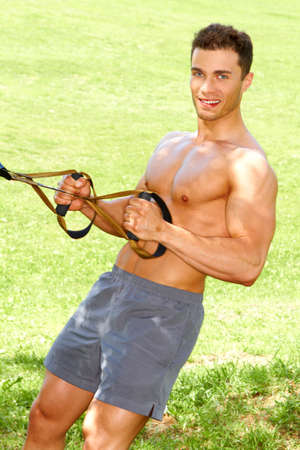 Muscular Male Improving his strength at outdoorの写真素材