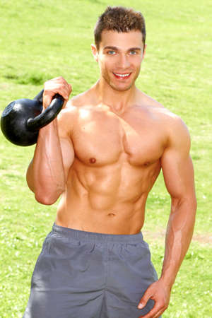 Fitness Man Working with kettlebell at outdoorの写真素材